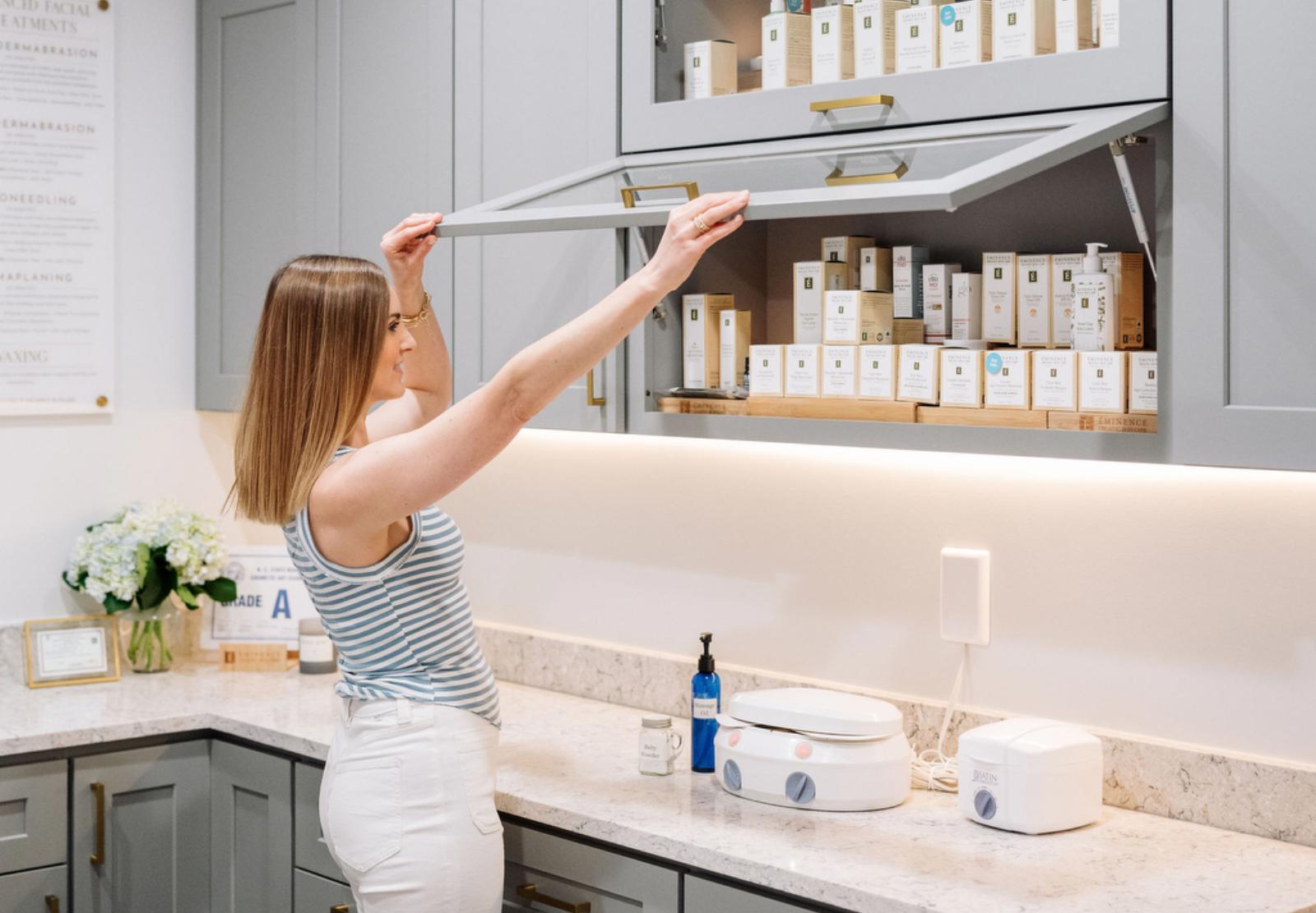 esthetician reaching for Eminence Organics skin care products