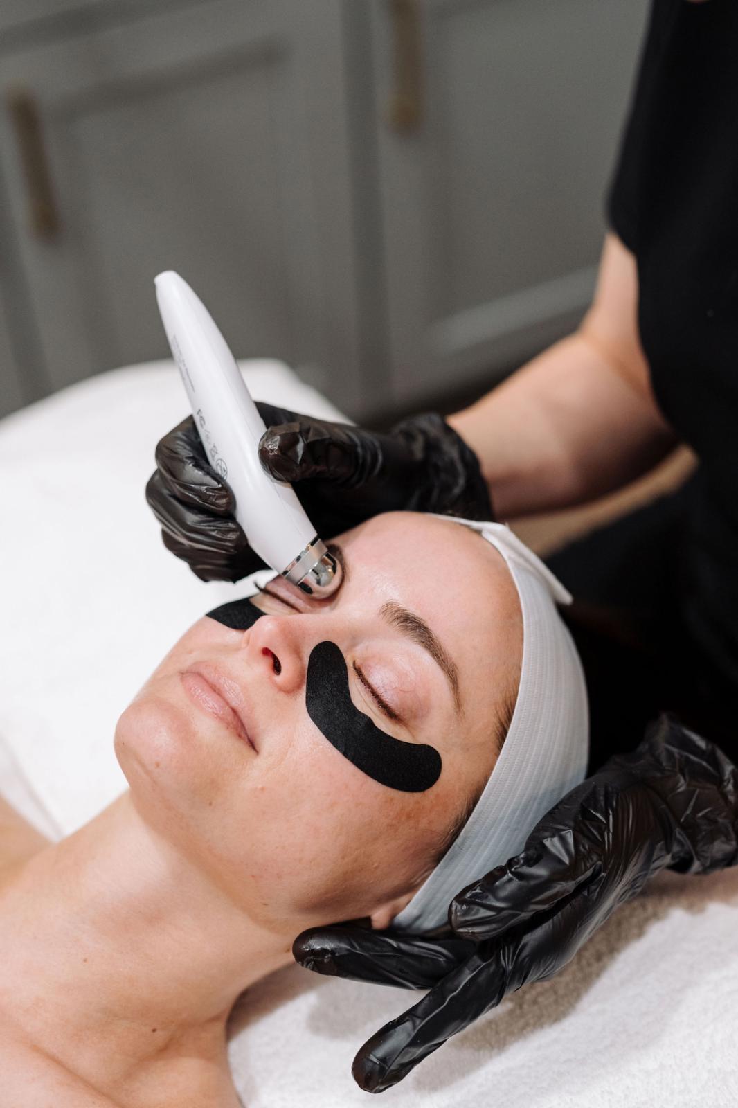 Client receiving a facial with an eye treatment